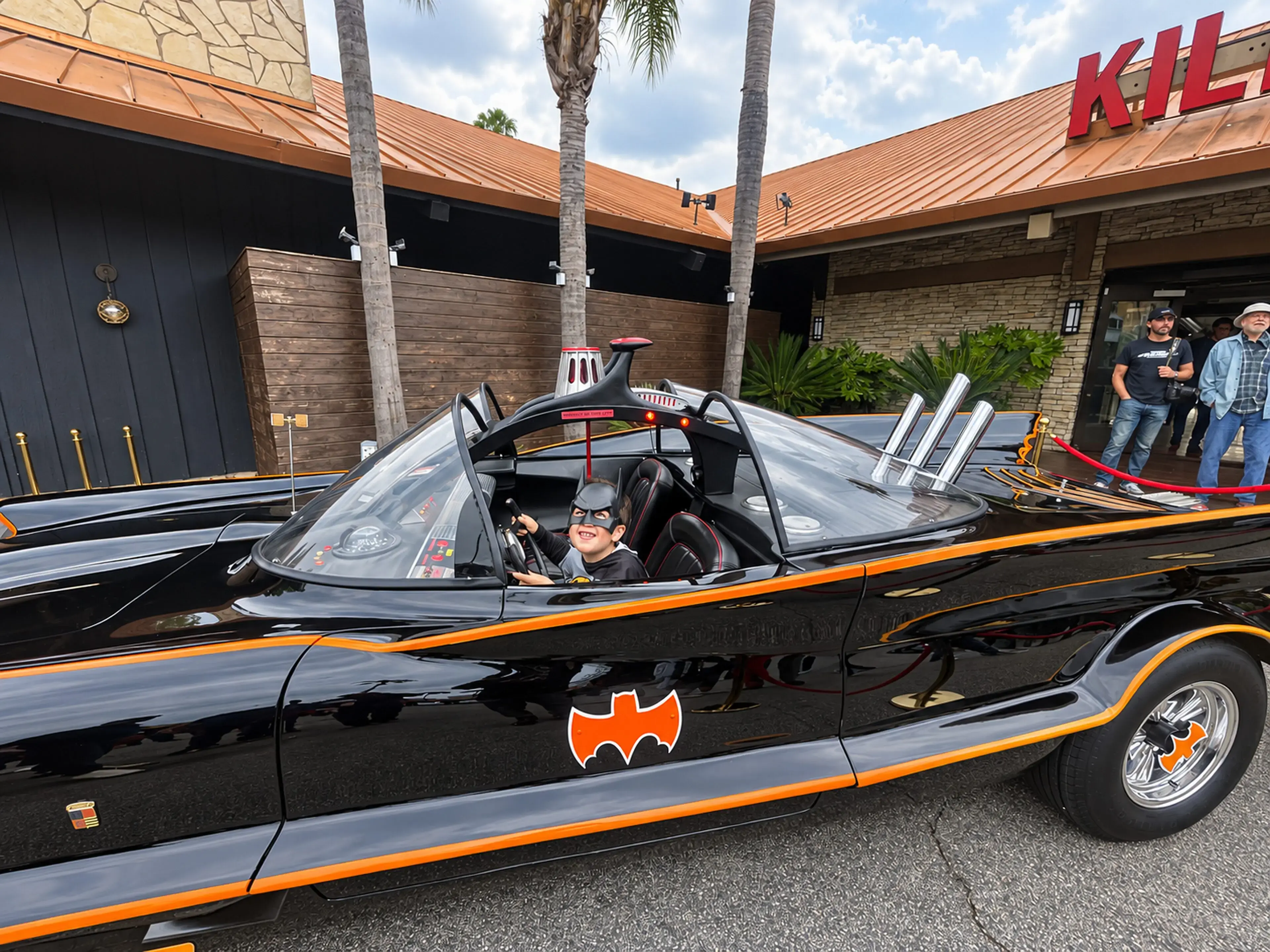 A child with the original television Batmobile at Zuma